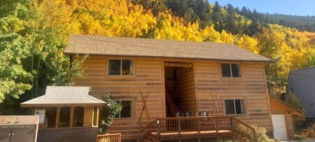 Outdoor view with aspen trees turning gold and red above Ski Town Condos.