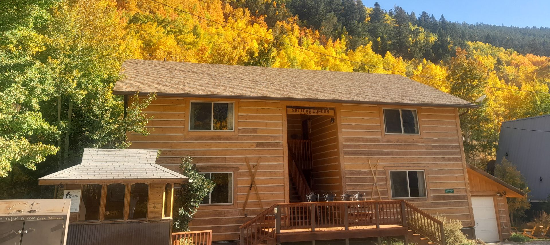 Outdoor view with aspen trees turning gold and red above Ski Town Condos.